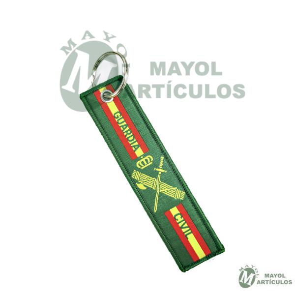 Llavero elaborado en tela por un lado Emblema sobre fondo verde y por el otro Bandera y Virgen del Pilar